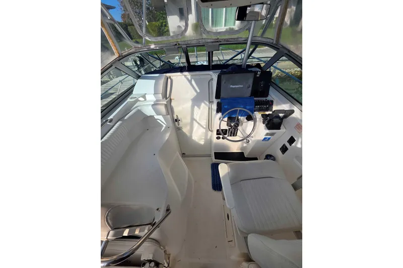 Slide: The Image of 2001 Boston Whaler 275 Conquest boat interior with steering wheel and seating. - 12