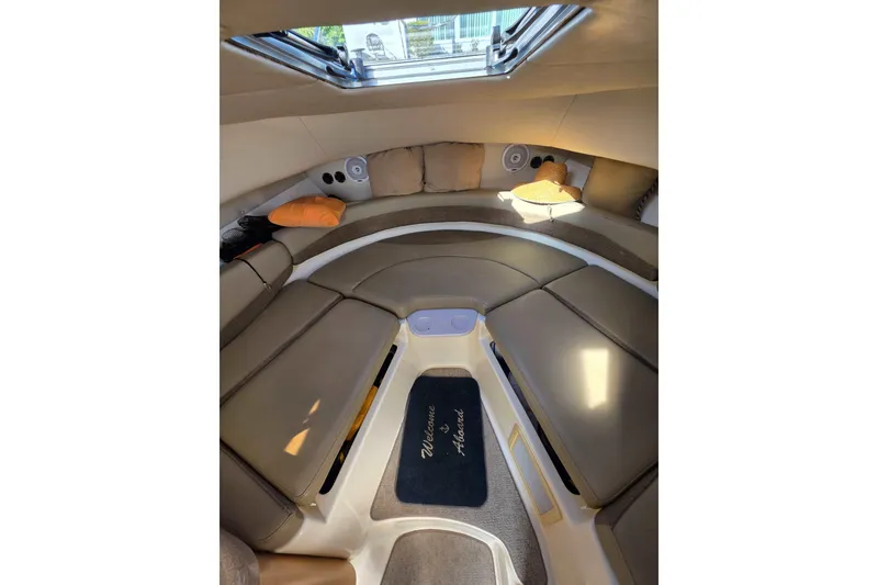 Slide: The Image of Interior cabin of 2001 Boston Whaler 275 Conquest with cushioned seating and skylight. - 13