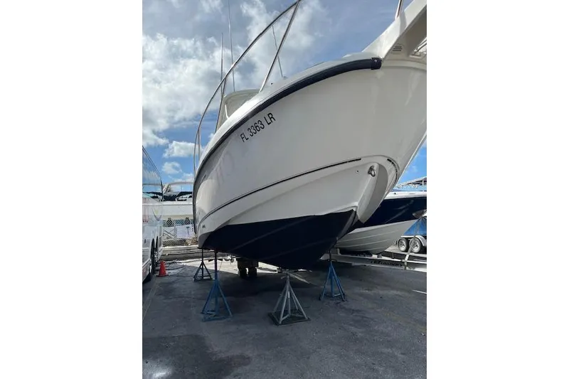 Slide: The Image of 2001 Boston Whaler 275 Conquest boat docked in a marina, front view. - 2