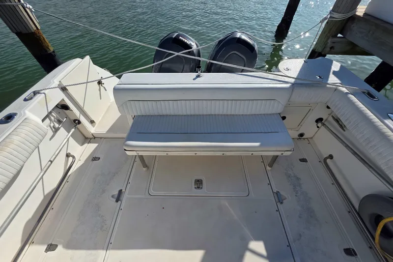 Slide: The Image of 2001 Boston Whaler 275 Conquest boat interior with seating and twin outboard motors. - 22