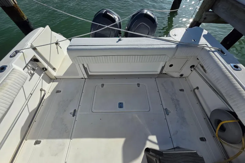Slide: The Image of 2001 Boston Whaler 275 Conquest boat deck with Yamaha engines, docked at marina. - 25