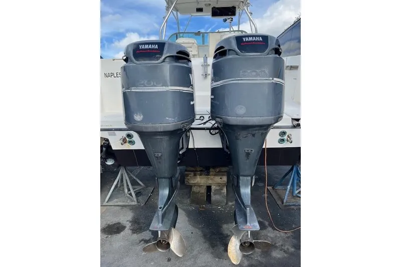 Slide: The Image of Boston Whaler 275 Conquest 2001 helm with steering wheel and navigation controls. - 8