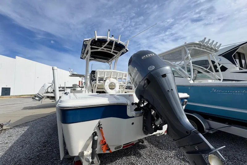 Slide: The Image of 2019 Wellcraft 221 Bay boat with Yamaha outboard motor, parked on gravel. - 10