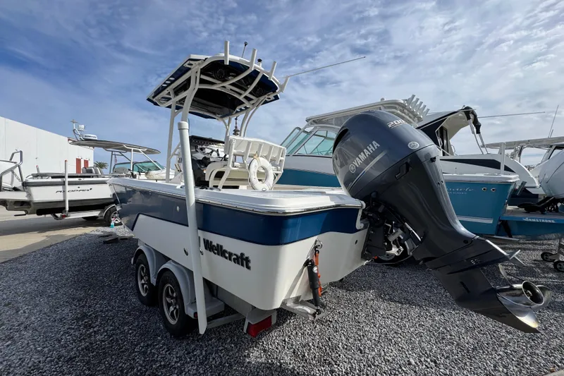 Slide: The Image of 2019 Wellcraft 221 Bay boat with Yamaha engine on a trailer, parked on gravel. - 11