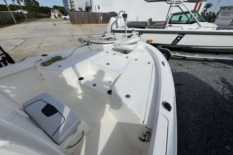 Slide: The Image of 2019 Wellcraft 221 Bay boat interior with seating and storage compartments. - 12