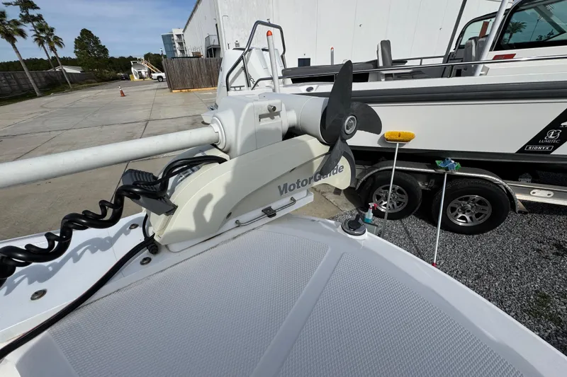 Slide: The Image of 2019 Wellcraft 221 Bay boat with MotorGuide trolling motor on trailer. - 16