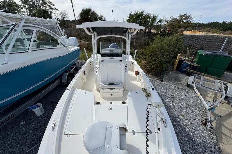 Slide: The Image of 2019 Wellcraft 221 Bay boat docked, featuring spacious deck and modern design. - 18