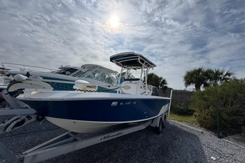 Slide: The Image of 2019 Wellcraft 221 Bay boat on trailer under cloudy sky. - 2