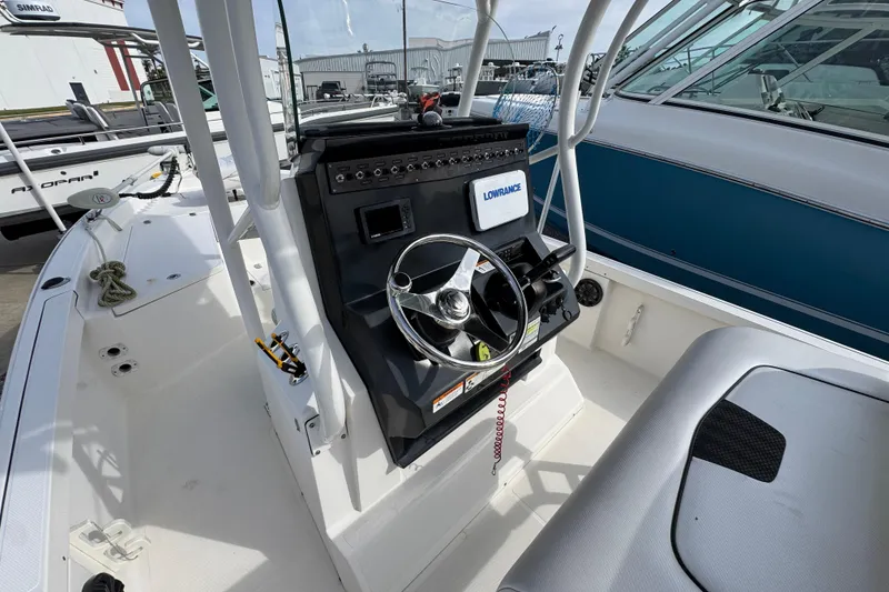 Slide: The Image of 2019 Wellcraft 221 Bay boat interior with steering wheel and control panel. - 22
