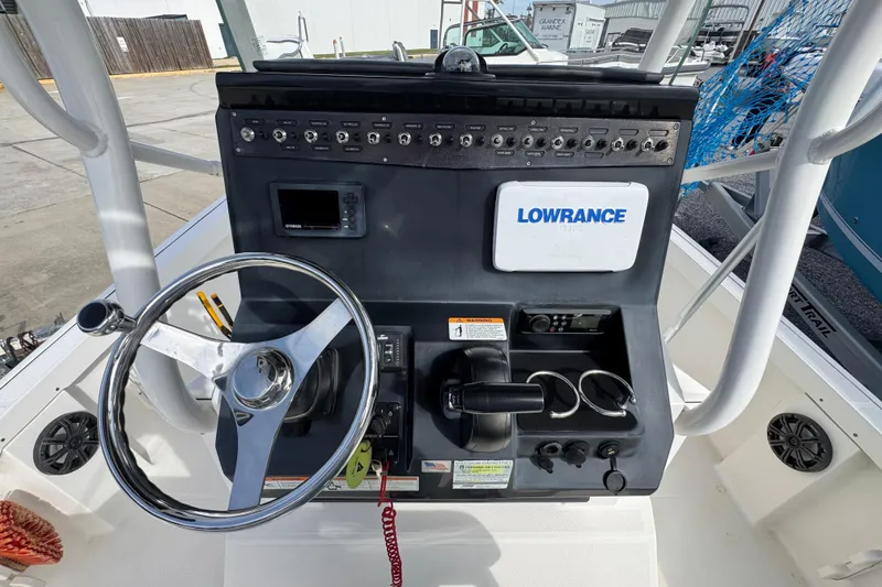 Slide: The Image of 2019 Wellcraft 221 Bay boat console with steering wheel and Lowrance electronics. - 23