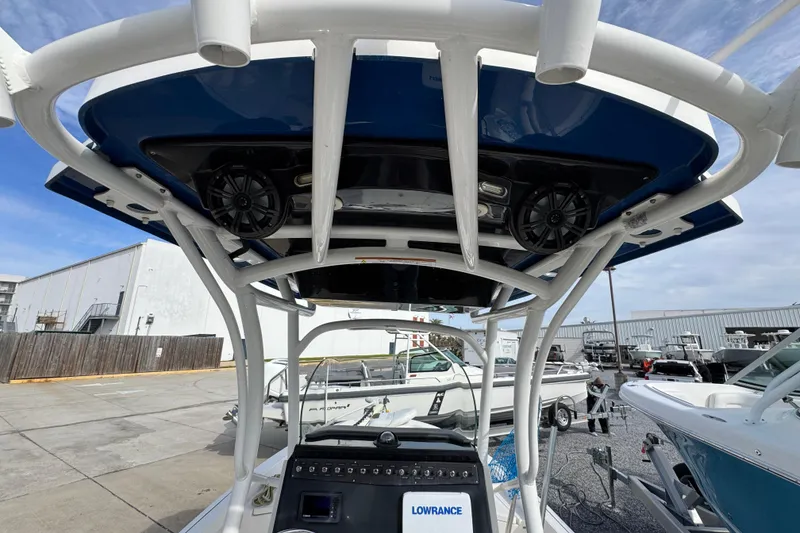 Slide: The Image of 2019 Wellcraft 221 Bay boat with T-top and electronics, docked in a marina. - 29