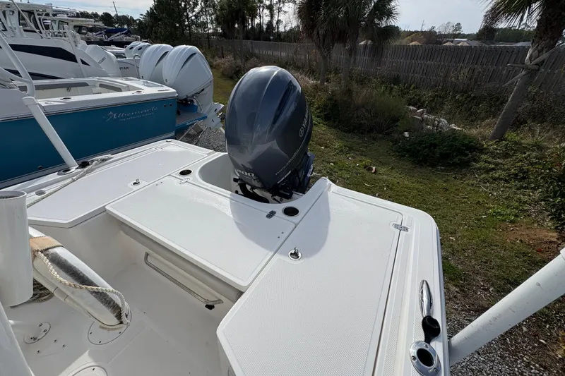Slide: The Image of 2019 Wellcraft 221 Bay boat with Yamaha outboard motor, parked outdoors. - 31