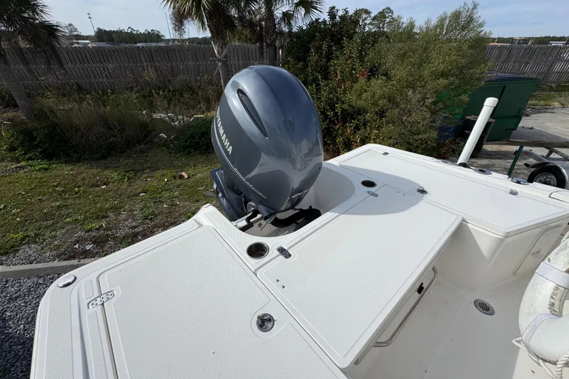 Slide: The Image of 2019 Wellcraft 221 Bay boat with Yamaha outboard motor, parked outdoors. - 33