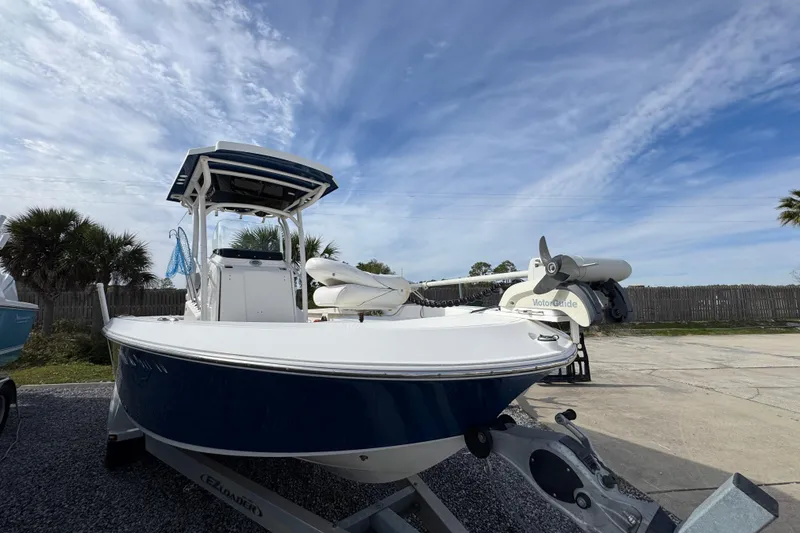 Slide: The Image of 2019 Wellcraft 221 Bay boat on trailer under a partly cloudy sky. - 5
