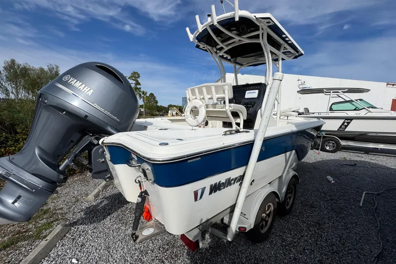 Slide: The Image of 2019 Wellcraft 221 Bay boat with Yamaha engine on trailer, parked outdoors. - 7