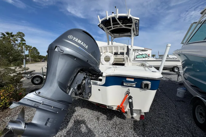 Slide: The Image of 2019 Wellcraft 221 Bay boat with Yamaha outboard motor, parked on gravel. - 8