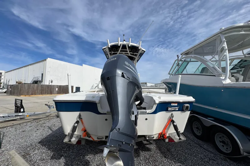 Slide: The Image of 2019 Wellcraft 221 Bay boat with Yamaha outboard motor, parked on gravel lot. - 9