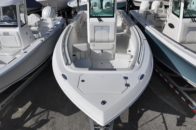 Slide: The Image of 2026 Sailfish 272 CC boat with sleek design and spacious seating, docked among other boats. - 10