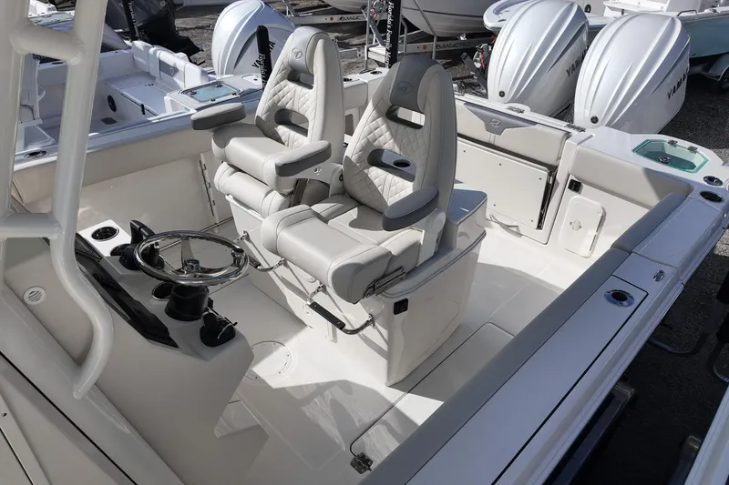 Slide: The Image of 2026 Sailfish 272 CC boat interior with dual captain's chairs and steering console. - 13