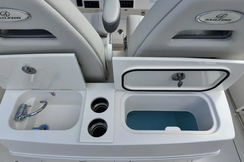 Slide: The Image of 2026 Sailfish 272 CC boat interior with sink, cup holders, and storage compartment. - 4