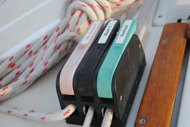 Slide: The Image of Close-up of sailboat rigging and cleats, Tartan 28, year 1988. - 12