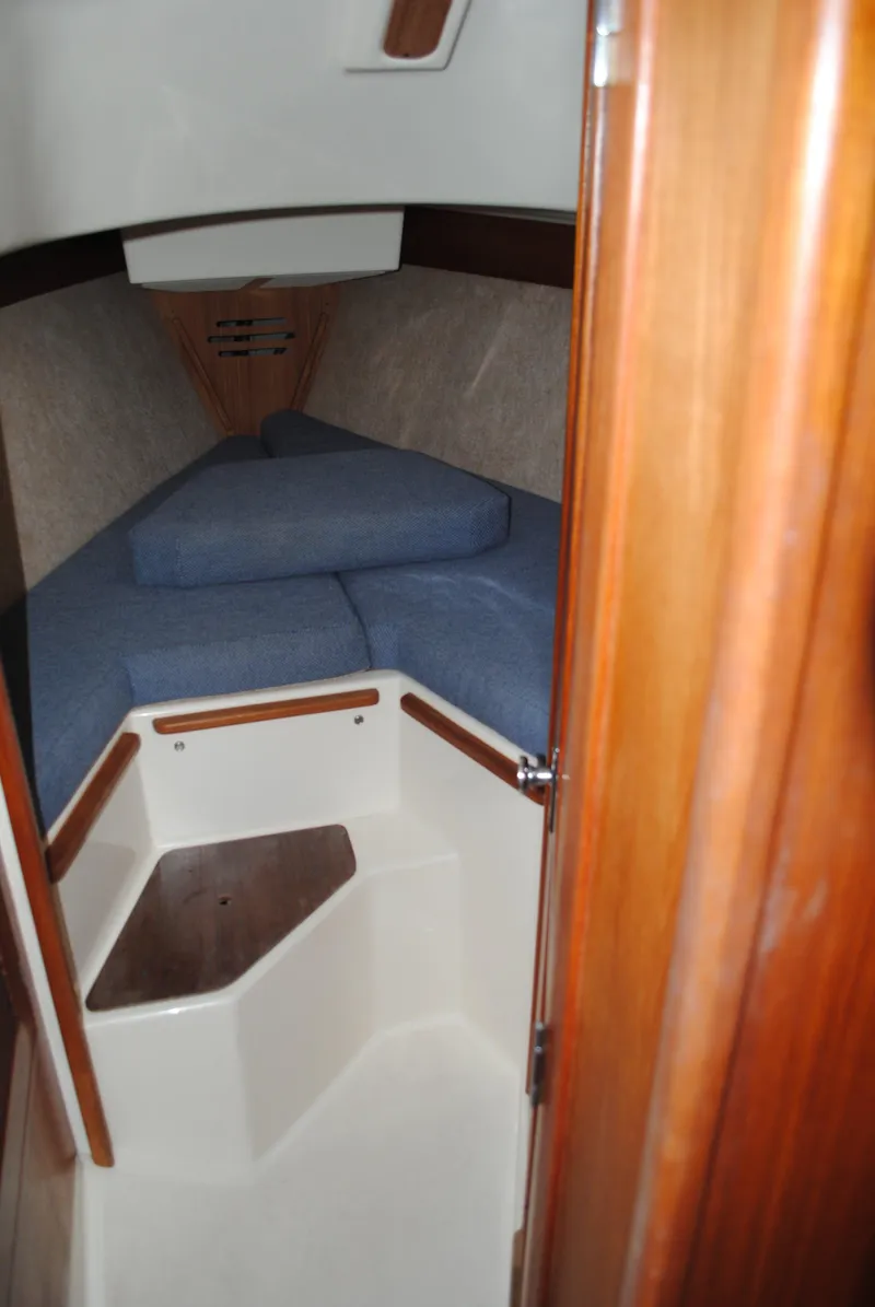 Slide: The Image of Interior of a 1988 Tartan 28 sailboat with blue cushions. - 20