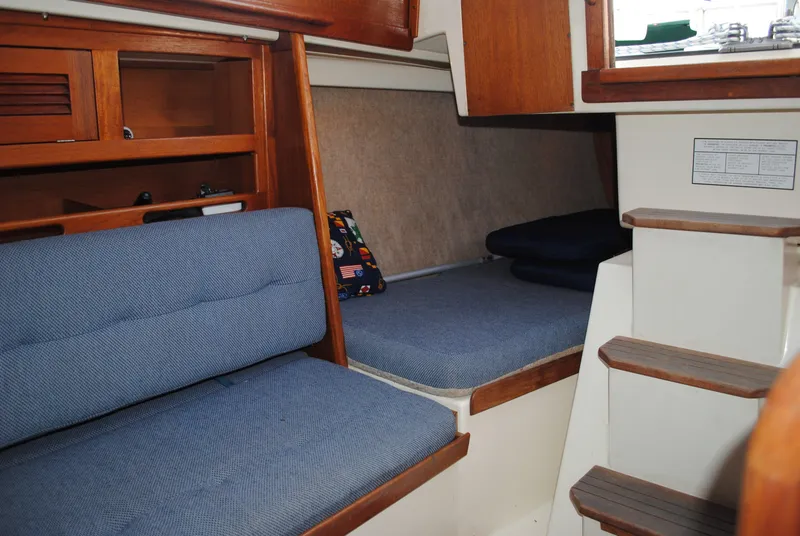 Slide: The Image of Interior of a 1988 Tartan 28 sailboat with blue upholstery. - 24
