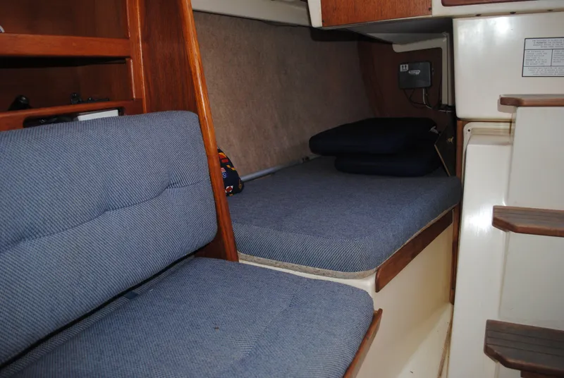 Slide: The Image of Interior of a 1988 Tartan 28 sailboat with blue cushions. - 30
