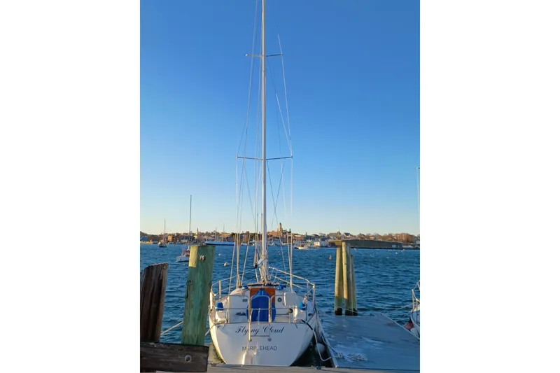 Slide: The Image of Sailboat Tartan 28, 1988 model, docked at a marina under clear blue sky. - 5