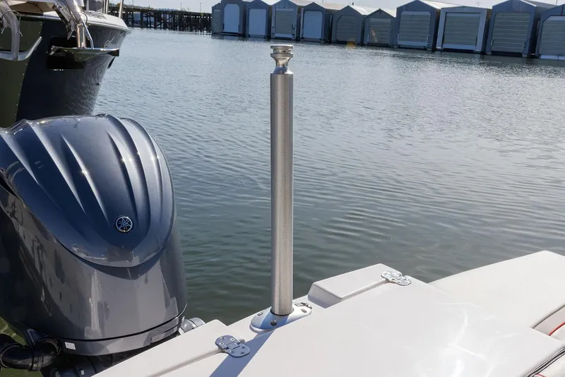 Slide: The Image of Manufacturer Provided Image: Boat docked by water with outboard motor, featuring Solara S-250 Coupe, 2025 model. - 17
