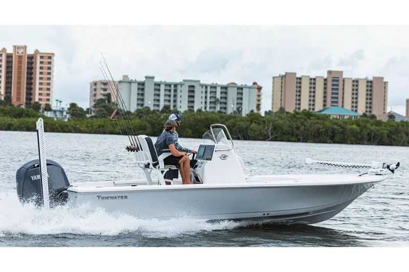 The Image of Manufacturer Provided Image: 2026 Tidewater 2110 Bay Max boat cruising on water near city skyline. - 0