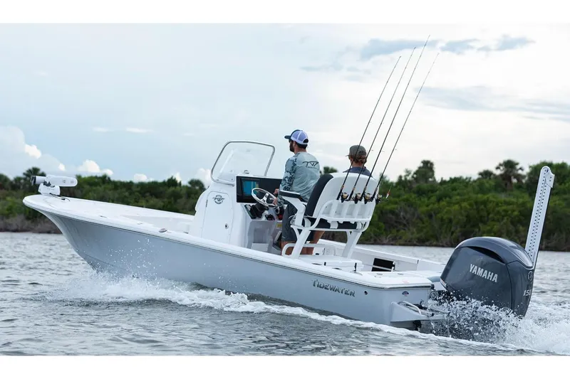 Slide: The Image of Manufacturer Provided Image: 2026 Tidewater 2110 Bay Max boat cruising on water with two passengers and fishing rods. - 2