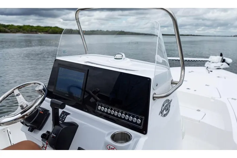 Slide: The Image of Manufacturer Provided Image: 2026 Tidewater 2110 Bay Max boat dashboard with steering wheel and navigation display. - 5