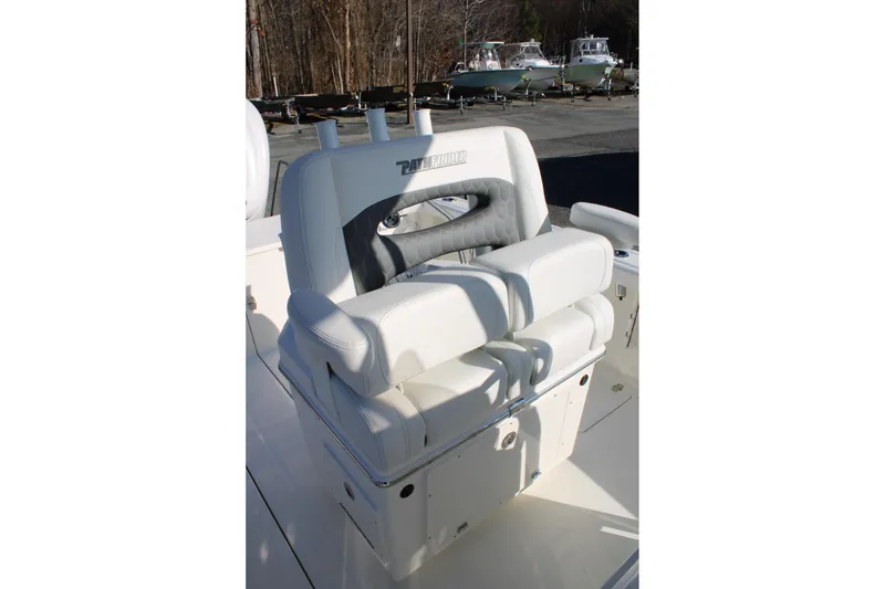 Slide: The Image of 2026 Pathfinder 2400 Open boat seat with white and gray upholstery, outdoor setting. - 11
