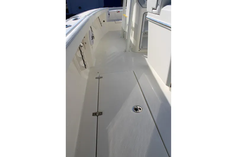 Slide: The Image of 2026 Pathfinder 2400 Open boat interior, showcasing sleek white deck and storage compartments. - 14