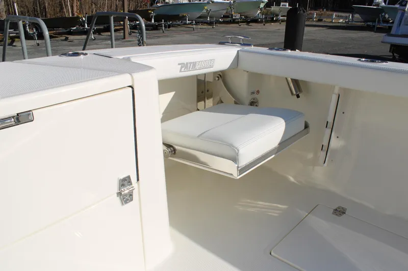 Slide: The Image of 2026 Pathfinder 2400 Open boat interior with foldable seat and storage compartment. - 18