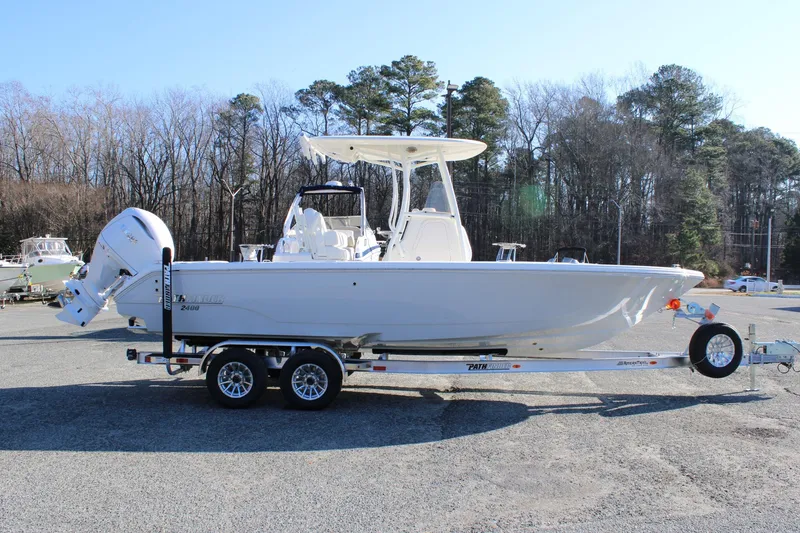 Slide: The Image of 2026 Pathfinder 2400 Open boat on trailer, parked outdoors, side view. - 5