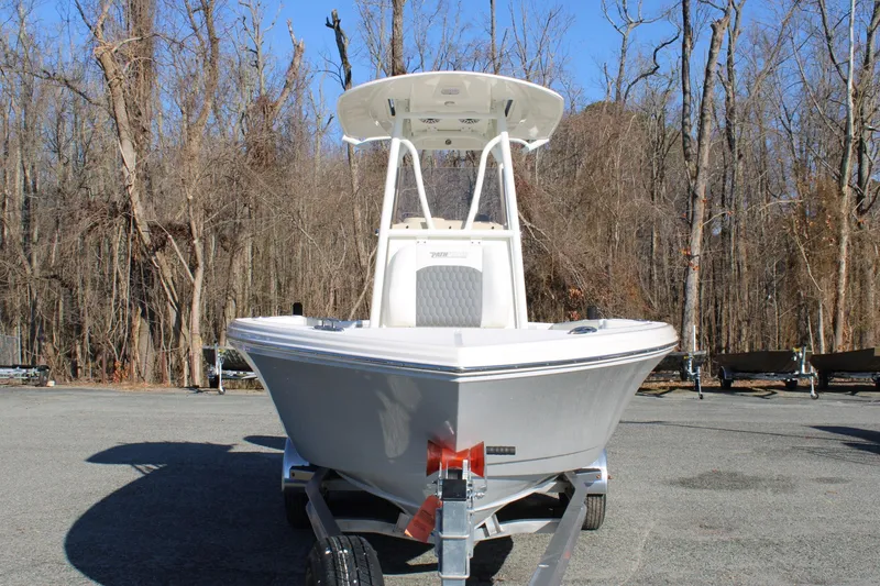 Slide: The Image of 2026 Pathfinder 2400 Open boat on trailer, parked in wooded area. - 7