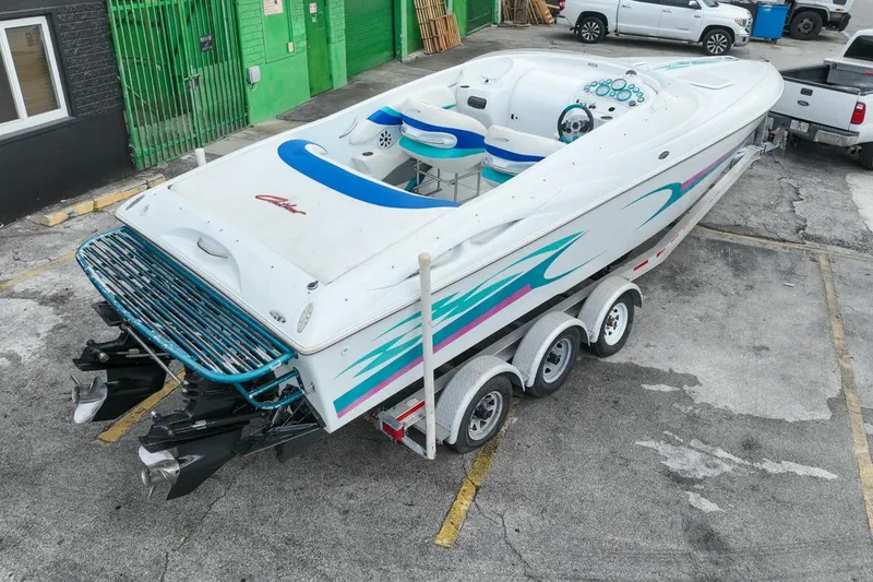 Slide: The Image of 1999 Baja 29 Outlaw boat parked on trailer. - 16