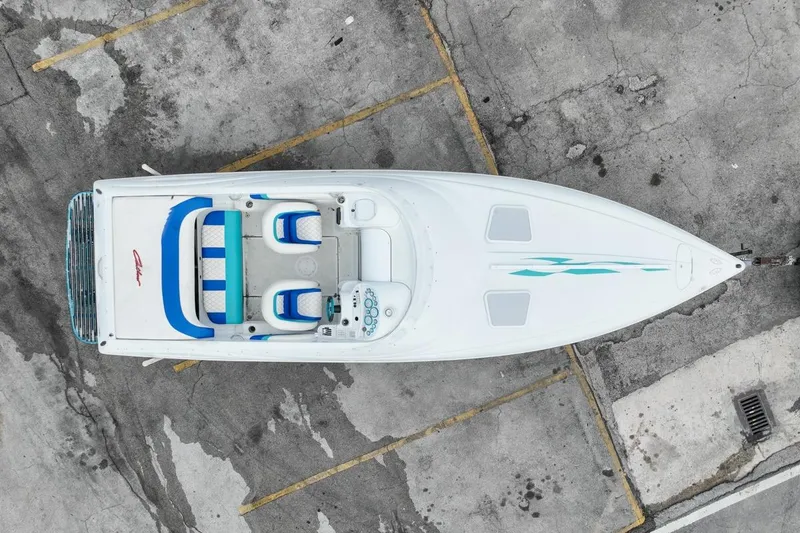 Slide: The Image of Aerial view of a 1999 Baja 29 Outlaw boat on asphalt. - 17