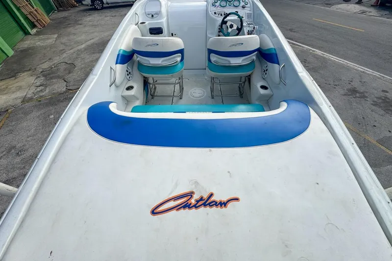 Slide: The Image of 1999 Baja 29 Outlaw boat interior with blue and white seating and dashboard. - 23