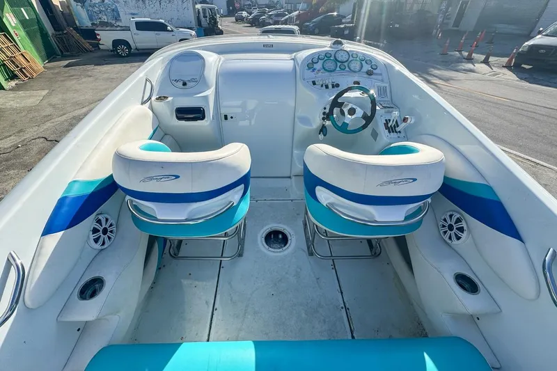 Slide: The Image of Interior of a 1999 Baja 29 Outlaw boat with blue and white seats. - 25