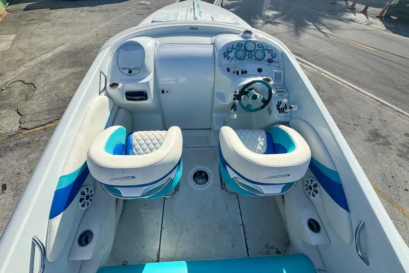 Slide: The Image of Interior of a 1999 Baja 29 Outlaw boat with blue and white seats. - 26