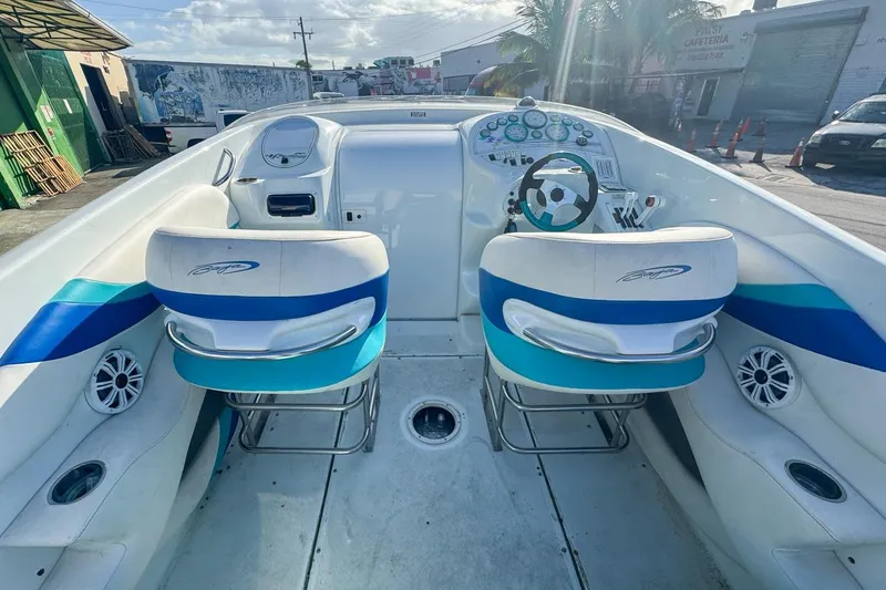 Slide: The Image of Interior of a 1999 Baja 29 Outlaw boat with blue and white seats. - 28