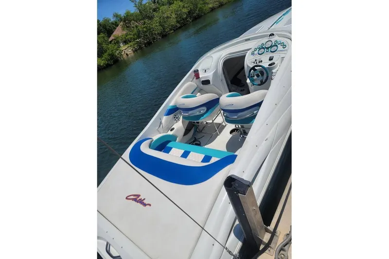 Slide: The Image of 1999 Baja 29 Outlaw speedboat on trailer, parked in industrial area. - 3