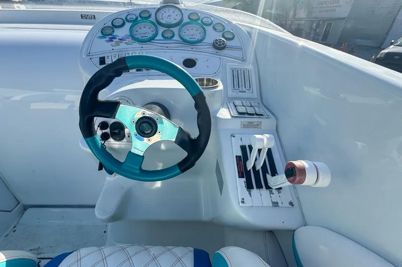 Slide: The Image of Cockpit of a 1999 Baja 29 Outlaw boat with steering wheel and gauges. - 36