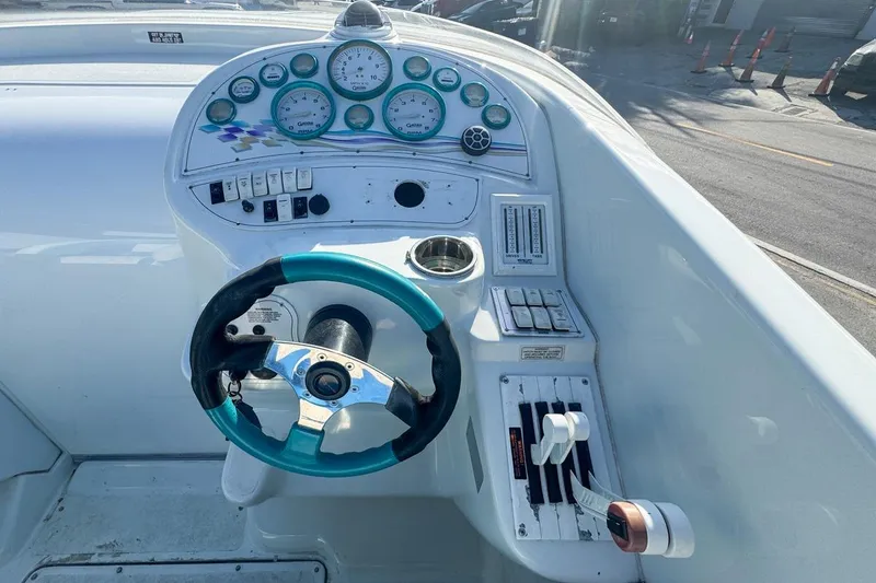 Slide: The Image of Cockpit of a 1999 Baja 29 Outlaw boat with steering wheel and gauges. - 38