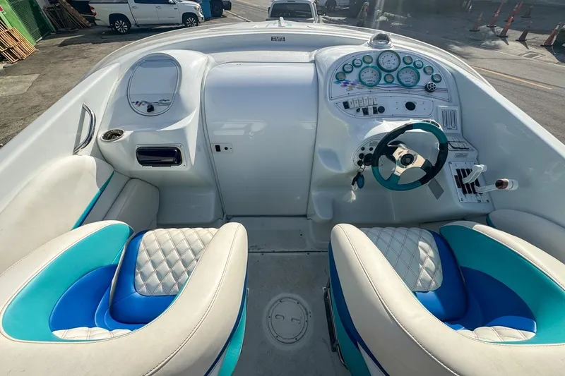 Slide: The Image of 1999 Baja 29 Outlaw boat cockpit with blue and white seating and dashboard controls. - 43