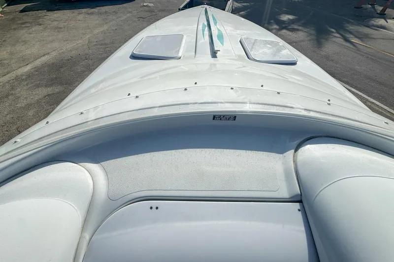 Slide: The Image of 1999 Baja 29 Outlaw boat deck, white with sleek design, viewed from above. - 46
