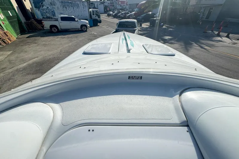 Slide: The Image of 1999 Baja 29 Outlaw boat on trailer in urban setting, viewed from bow. - 48